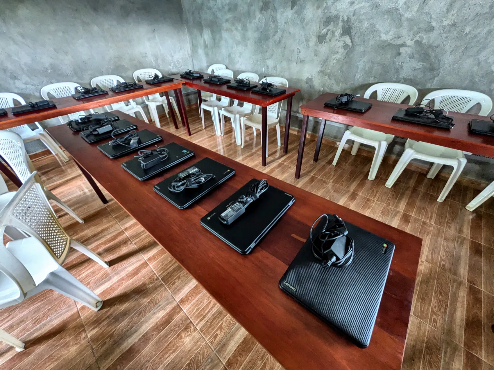 Rows of laptops laid out in a newly connected rural classroom
